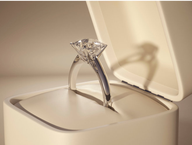 A diamond ring is shown in a box. The word "carat" is about weight, not size.